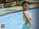 A woman in a swimming pool smiling at the camera.