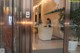 A woman standing at a reception desk in a building.