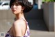 A woman in a floral dress is posing for a picture.